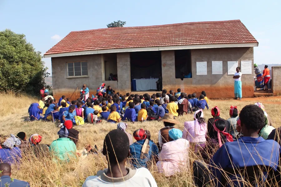 Community meeting held outdoors during a field engagement